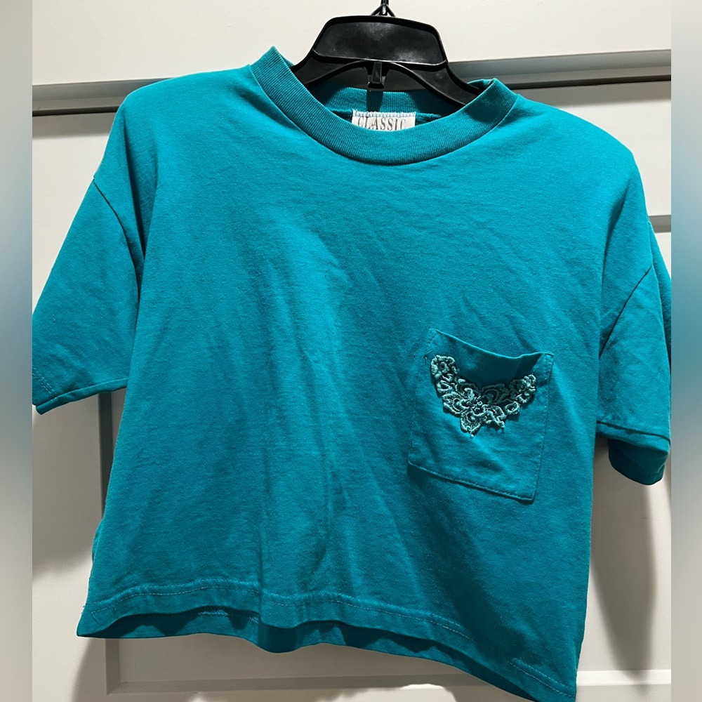 Classic Moves Teal Crop Top with appliqué pocket and shoulder pads